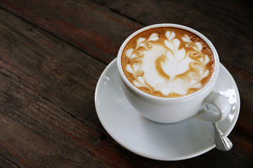 cup of hot coffee on the wood table in coffee shop cafe