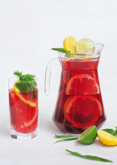 tasty and juicy sangria with citrus in a glass on a white background