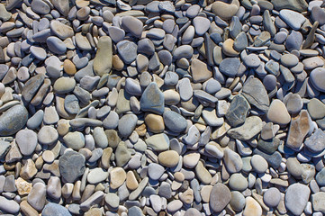 Sea pebbles. Small stones gravel texture background.The pile of pebbles, Noumea.The color of the stone in the background.