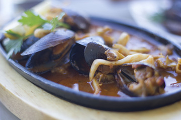 Steamed mussels in sauce served in a pan