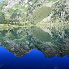 Reflection of a mountain on a  Pyrenean lake in. Ariege in Occitanie. South of France