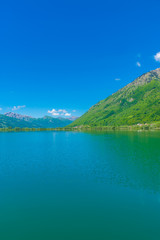 A picturesque mountain lake is located in a valley among the mountains.