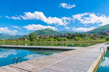 A picturesque mountain lake is located in a valley among the mountains.