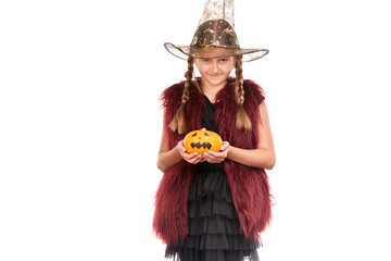 Portrait of little girl with braids posing in Halloween costume against white background