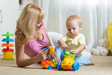 cute mother and child boy playing together indoors at home