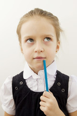 Portrait of pensive little schoolgirl isolated on a white background