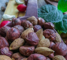 hazelnut and almonds in a wooden spoon on a table.