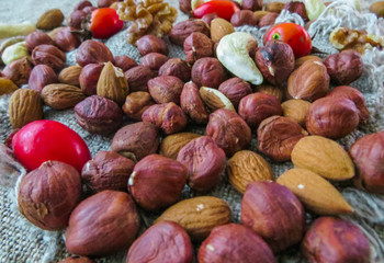 hazelnut and almonds scatter on the table, along with the rose hips and mint leaves.