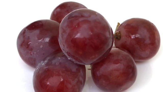 A lot Red Grapes White background wet water droplet, authentic motion rain water droplets natural fruti