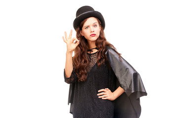 Fototapeta premium Young woman in Halloween costume posing against white background in studio