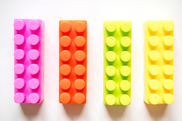 Multi color square plastic toy block on white background