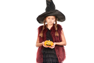 Portrait of little girl with braids posing in Halloween costume against white background