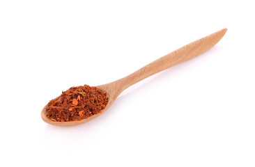wood spoon of cayenne pepper isolated on white background
