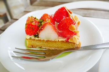 Close up japanese strawberry tart on white plate background.