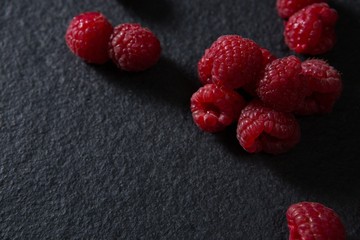 Raspberries on black background