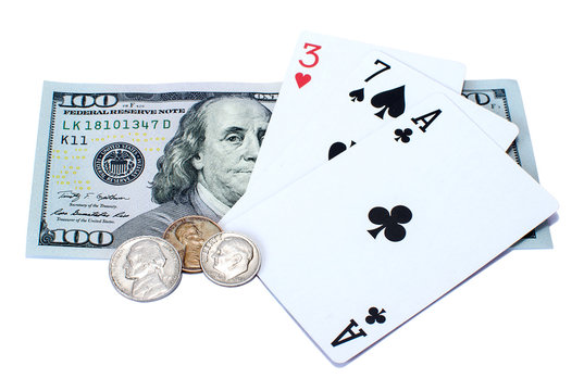 Banknote of one hundred dollars, coins and playing cards isolated on a white background