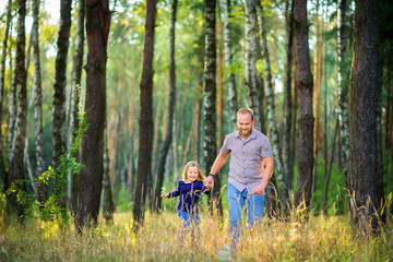 dad walks in the park with his beloved daughter, run and have fun