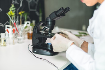 Young scientist using a microscope