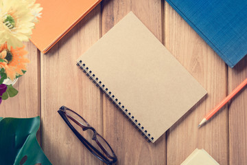 top view book and pencil note on wood table