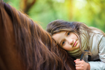 a girl strolls on her horse, active rest