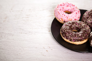 Close up of delicious donuts in black plate