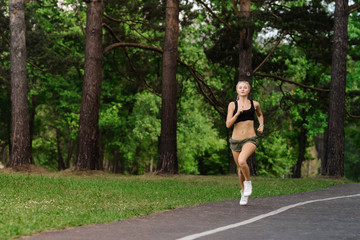Beautiful athletic girl running in the park