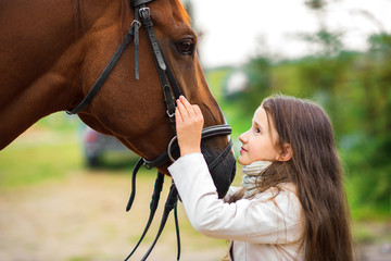 girl at the ranch, hugs her horse