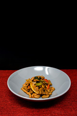 wok fried chicken stir fry with sweet peppers and chinese vegetables