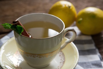 Cup of tea with lemon and cinnamon stick
