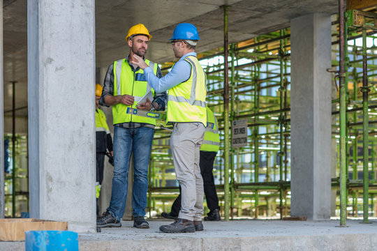 Construction workers in discussion on building site