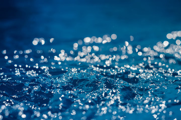 Blue background of water with highlights. Small depth of field