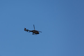 Fototapeta na wymiar Helicopter in the blue sky