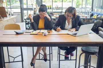 Business women are feeling stressed while working hard in their work.