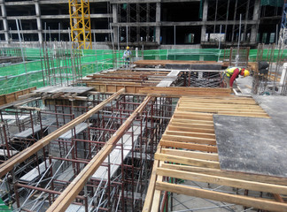 Timber form work and steel reinforcement bar fabricated by construction workers at construction site 