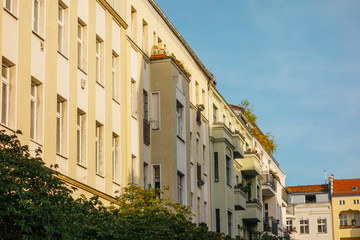 Fototapeta na wymiar yellow apartment house with shadow on the facade