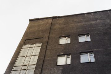 The wall of a factory building with windows