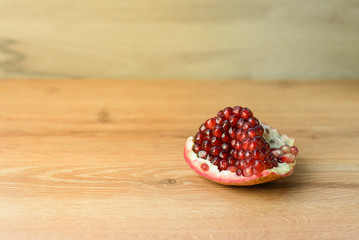 Ripe pomegranate fruit on wooden vintage background.