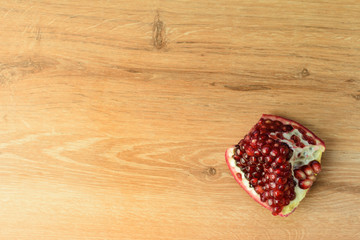 Fototapeta na wymiar Ripe pomegranate fruit on wooden vintage background.