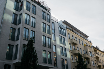 modern grey house next to an other building in warm colors