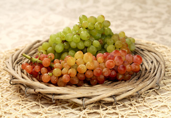 Juicy fresh red and white grapes  in a wattled basket