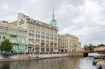 Fototapeta na wymiar Moyka River with the Red Bridge and the department store Au Pont Rouge in Saint Petersburg, Russia