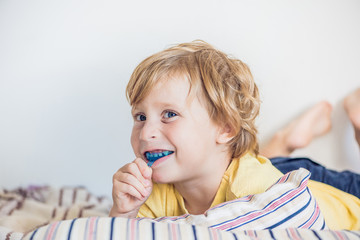 Three-year old boy shows myofunctional trainer to illuminate mouth breathing habit. Helps equalize...