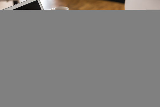 Laptop, bar chart and smartphone on office desk