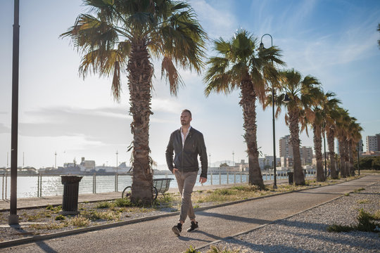 Man strolling on promenade, Cagliari, Sardinia, Italy, Europe