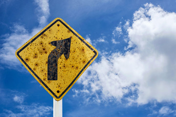 Traffic sign of the curve with blue sky background