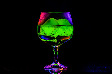 glass with artificial ice on an abstract background