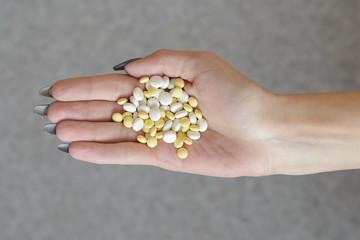 Fototapeta premium pills in a female hand