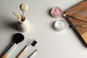 beauty concept : cosmetics top view on a white table. Workplace, cosmetic bag
