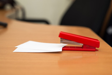 red stapler on the table