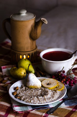 Breakfast with porridge, pear and tea 